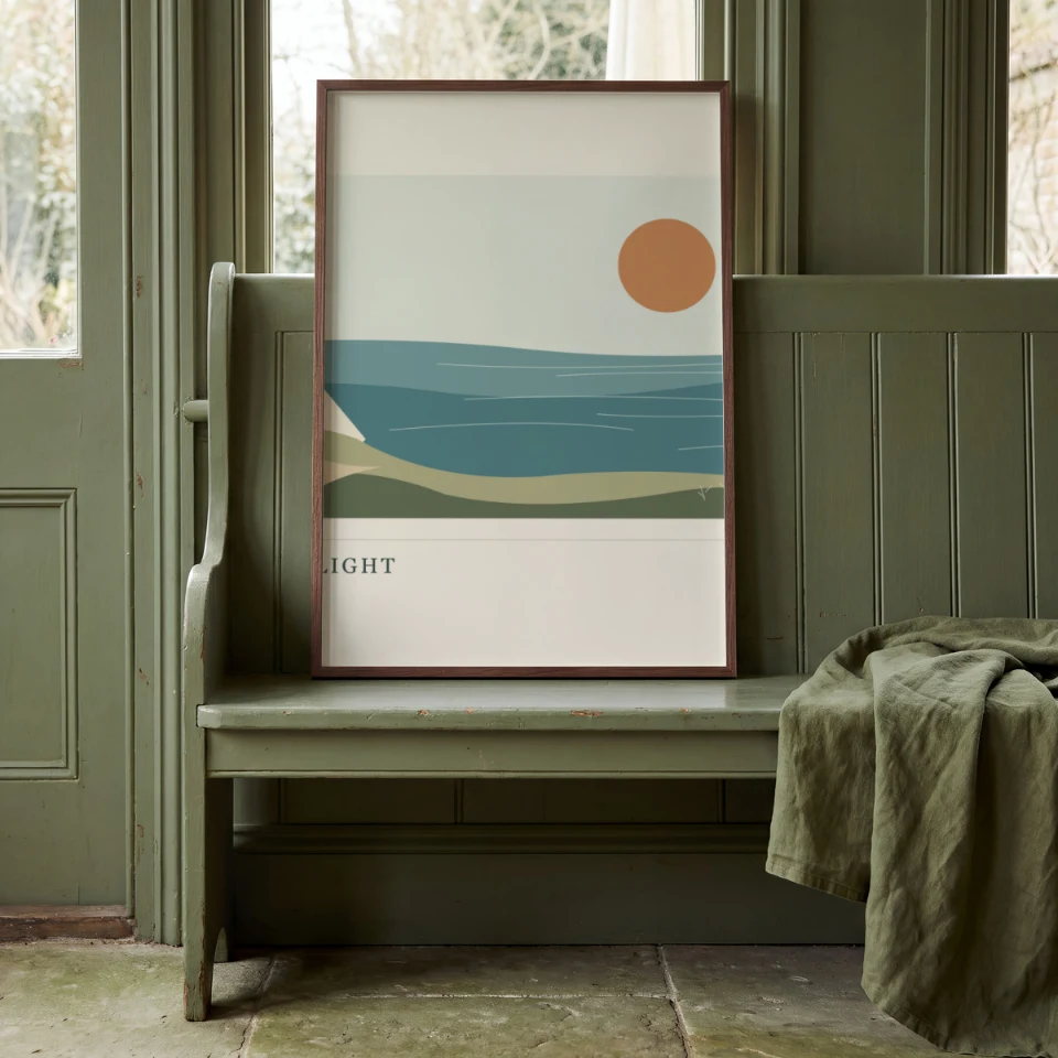 Sage Settle: Present your artwork in a slim walnut portrait frame leaning on a sage-green painted settle bench.