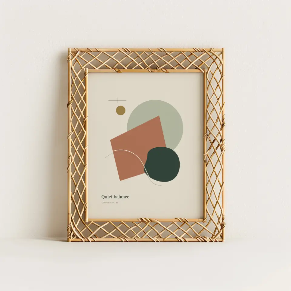 Golden Lattice Portrait: A gold frame woven in an open diamond lattice leans against a warm ivory wall, its criss-crossed strands casting fine shadows on the surface behind.
