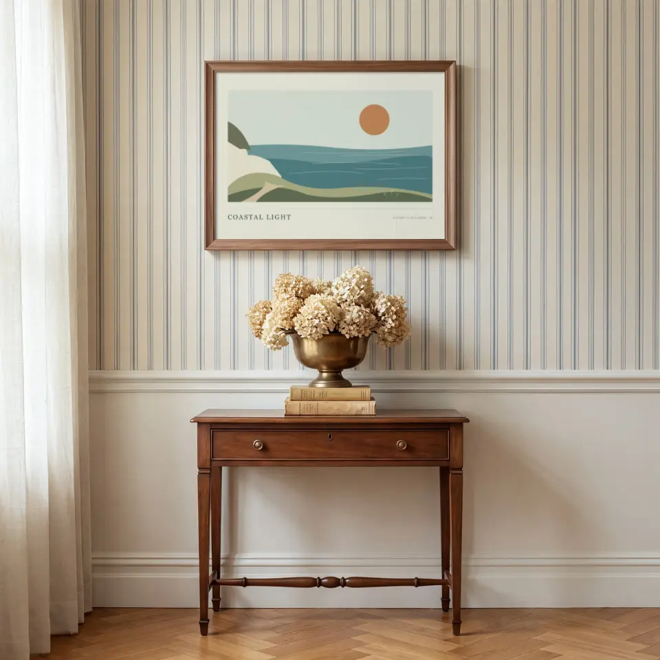 Striped Hall Arrangement: A walnut frame hangs above a slim antique console in a hall papered with fine cream and blue pinstripes over white wainscoting.