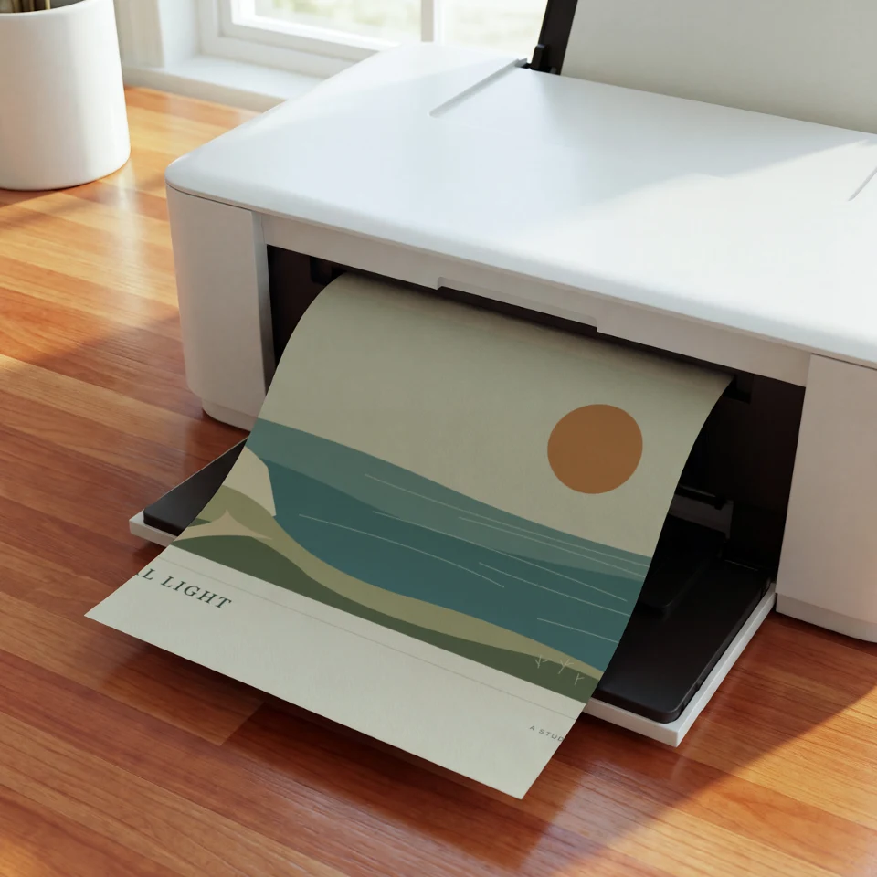 Sunlit Printer Curl: Present your artwork as a fresh print curling out of a white home printer onto its tray, on warm wooden floorboards in bright window light.